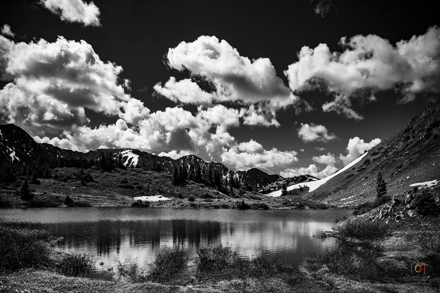 Black and White photograph of a high alpine lake on Loveland Pass with mountains in the background