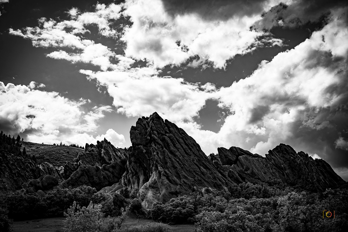 Black and White photograph of a red rock formation pointing towards the sky at Roxbrough Park
