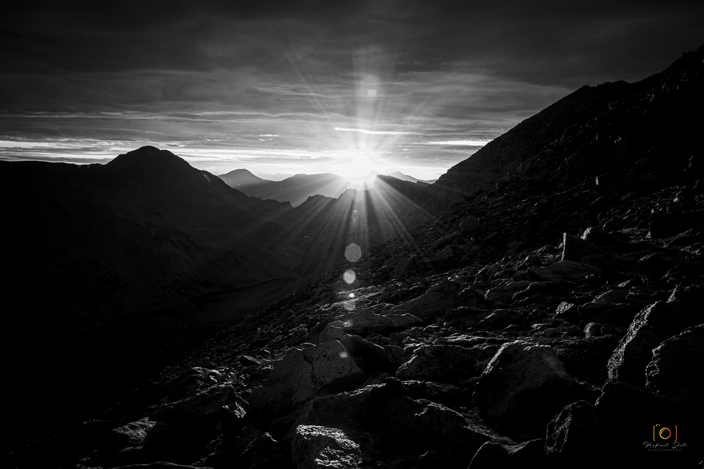 Black and White photograph of A photograph of a sunset from Mt. Evans looking west.